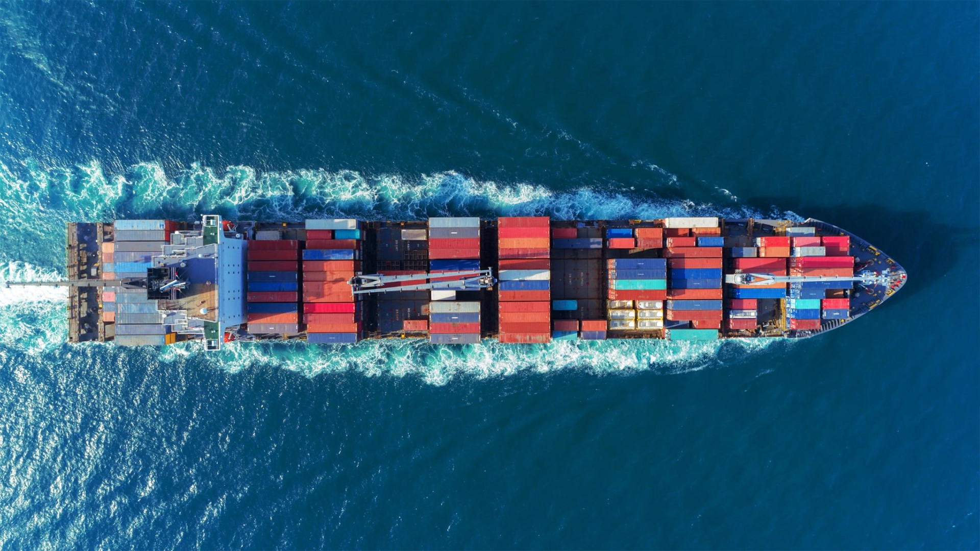 Aerial View Top Speed With Beautiful Wave Of Container Ship Full Load