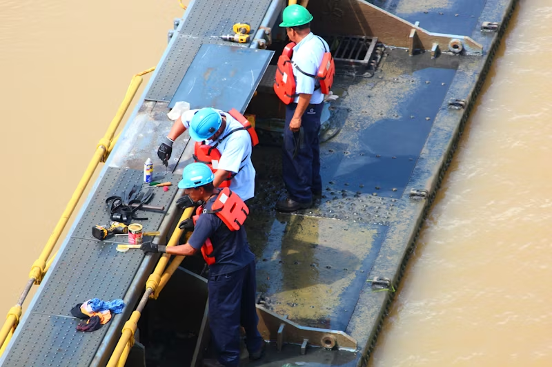 An image of marine engineers on the edge of a vessel