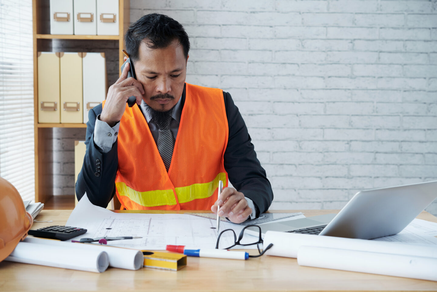 Asian male engineer in uniform working in the office