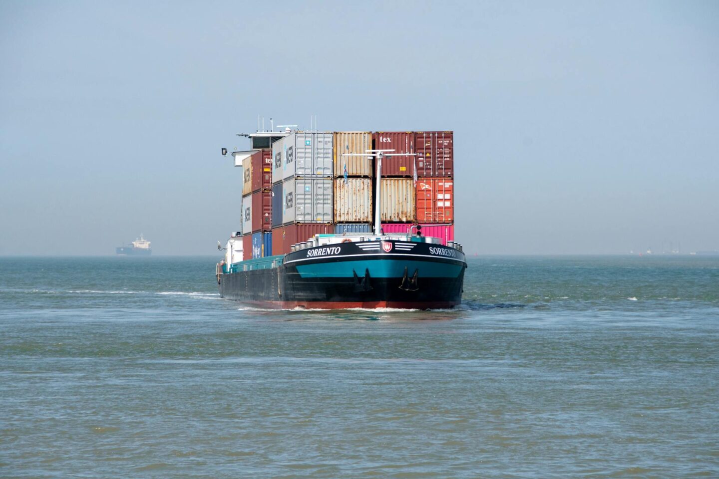 An image of a cargo vessel being maintained by a marine company in Singapore.